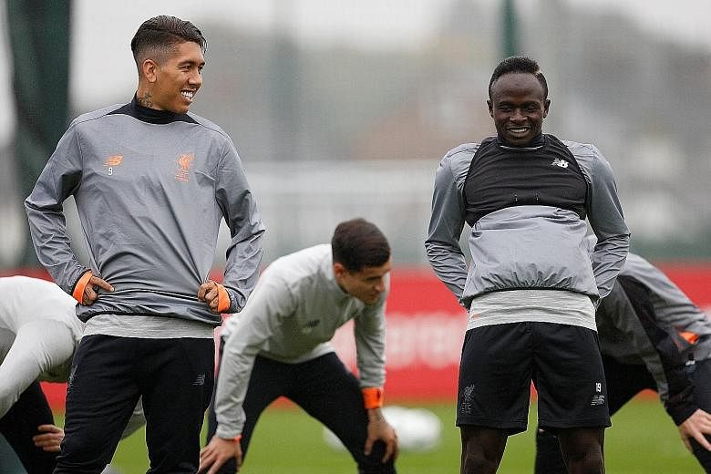 Roberto Firmino (foreground, left) and Sadio Mane during a training session. The Brazilian, who scored twice in Liverpool's 5-1 win at Brighton last Saturday, has notched five goals in his five Champions League appearances this season and will be a p