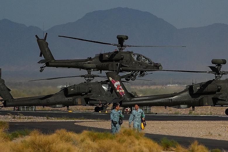 Apache helicopters taking off at Gila Bend Air Force Auxiliary Field in Arizona on Monday during the Forging Sabre exercise. The 16-day live-firing exercise, which began on Nov 28, features upgrades to weapon systems and involves a record 800 personn