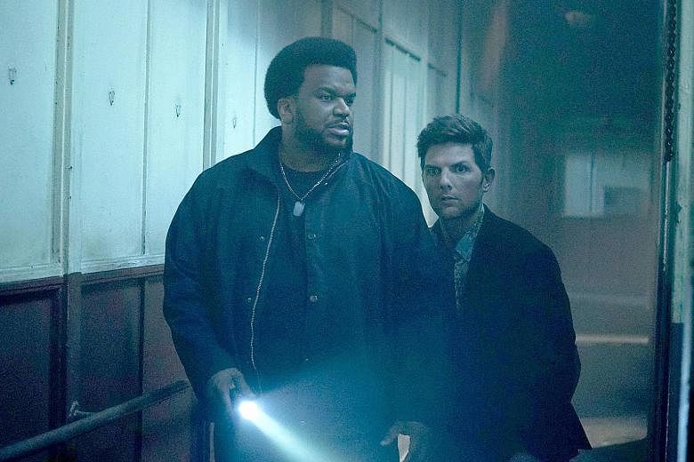 Actors Craig Robinson (left) and Adam Scott in Ghosted.
