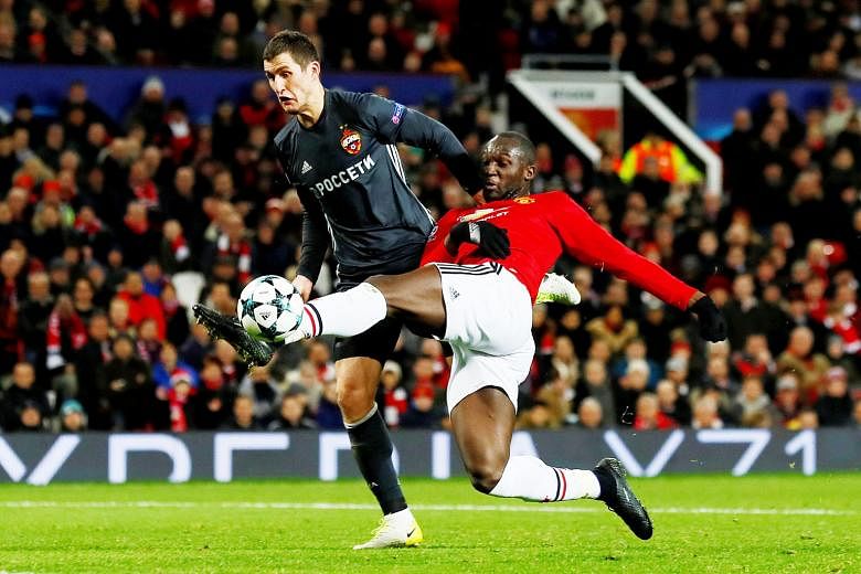 Romelu Lukaku holding off Viktor Vasin to volley in Manchester United's equaliser against CSKA Moscow from Paul Pogba's pass. Marcus Rashford scored the winner for United to enter the Champions League last 16 as group winners.
