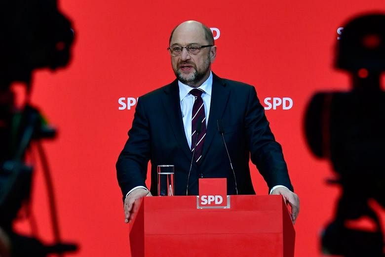 SPD leader Martin Schulz (right) has come under pressure from other European leaders to end Germany's political stalemate by forming a coalition with Chancellor Angela Merkel's (above) party.