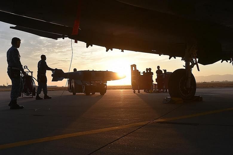 A GBU-31, which is a GPS-guided precision munition that can accurately target and destroy large or heavily fortified structures, is ready to be loaded onto an F-15SG fighter jet.