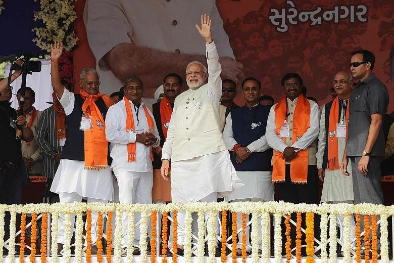 Indian Prime Minister Narendra Modi before the start of a rally on Sunday in Surendranagar, Gujarat. He hopes to fight off a stiff challenge from opposition Congress' Mr Rahul Gandhi.