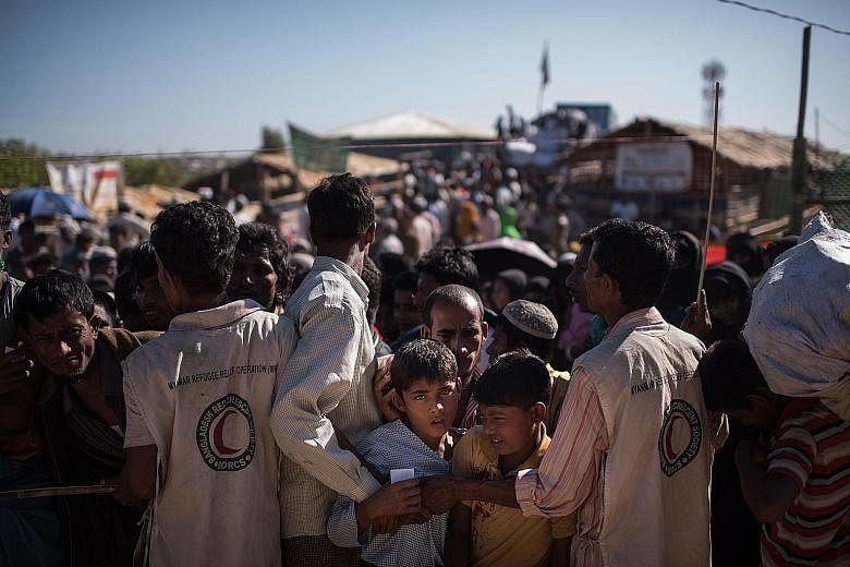 Rohingya refugees waiting for aid supplies at Kutupalong refugee camp in Cox's Bazar, Bangladesh, on Monday. In a new report, the International Crisis Group warned against imposing further sanctions on Myanmar over the refugee crisis, saying these ar