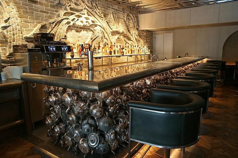 The reception table (above) is made from natural crystal from Madagascar. The Teapot Bar is decorated with 360 vintage teapots. A 6m-long pine log is turned into the bar counter at The Double. The feature wall in the private dining room is by Austral