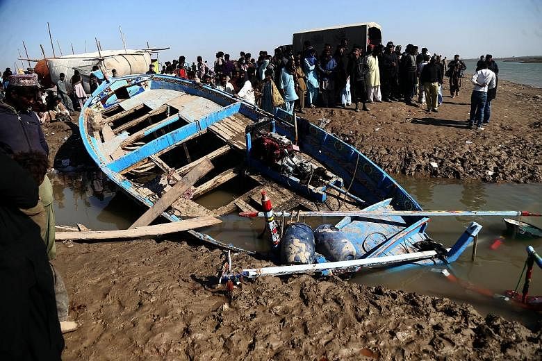 Devotees gathered around a boat that capsized on Thursday while carrying pilgrims to a Sufi Muslim shrine in Pakistan's Sindh province, near the ancient city of Thatta. Media reports said at least 26 people were killed, including women and children, 