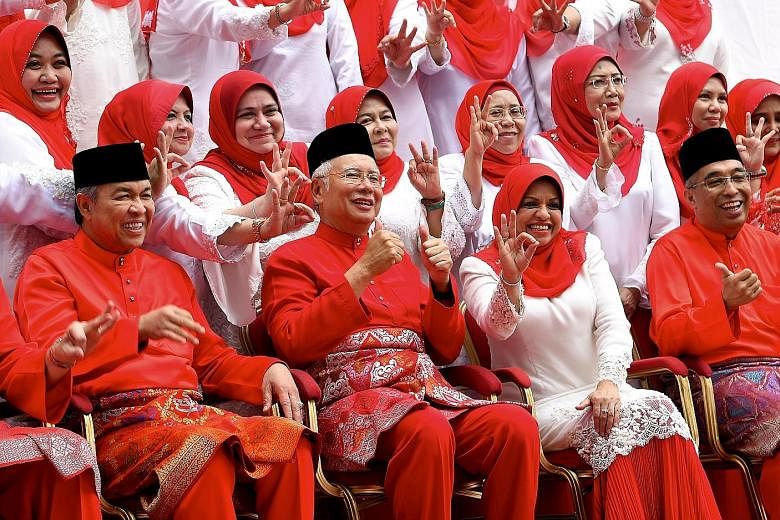Datuk Seri Najib Razak (seated, second from left) posing for photos with the Umno Women's wing executive committee on Thursday. Flanking him are (from left) Umno deputy president Ahmad Zahid Hamidi, Umno Women's chief Shahrizat Abdul Jalil and Umno t