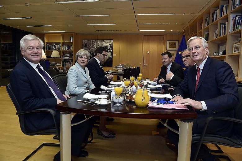 Britain's Secretary of State for Exiting the European Union David Davis (far left) and British PM Theresa May with the European Union's chief Brexit negotiator Michel Barnier (far right) and European Commission President Jean-Claude Juncker (second f