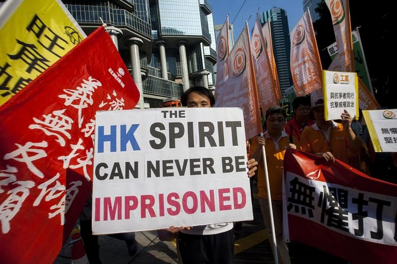 A march to show support for political activists in Hong Kong on Sunday. According to political scientist Francis Fukuyama, democratic accountability and public participation follow regulation by rule of law.
