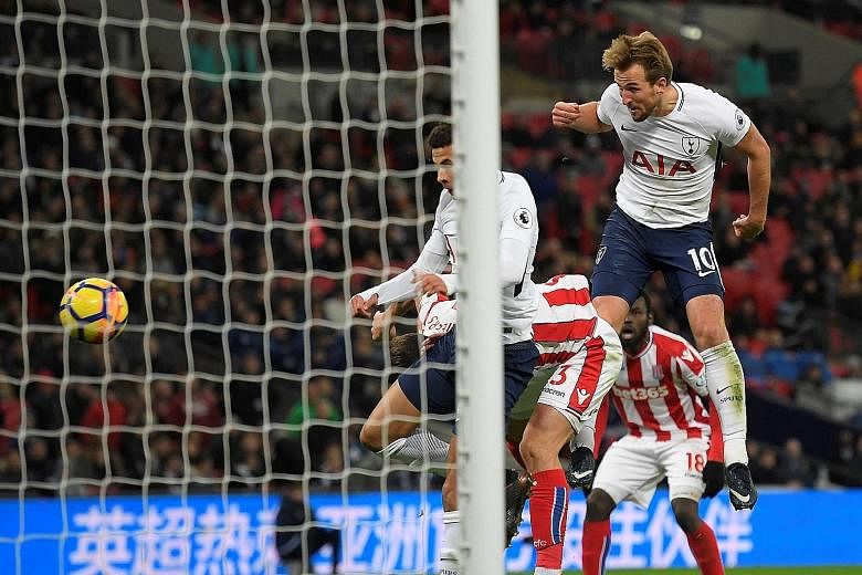 Harry Kane heads home a cross from Ben Davies in the 54th minute to put Tottenham 3-0 up against Stoke City yesterday at Wembley. The England striker added another in the second half for his brace. A first-half own goal from Ryan Shawcross - who also
