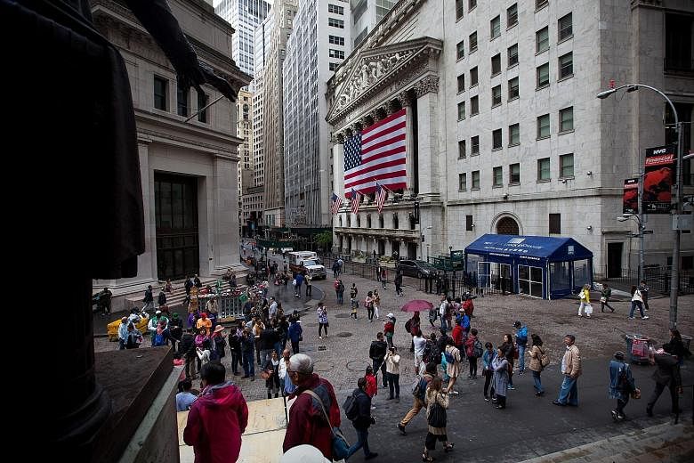 Wall Street in New York. The Dow Jones Industrial Average is up by almost 25 per cent for this year, and the rally is almost certain to continue this week, said Bank of America Merrill Lynch Global Research in a note.