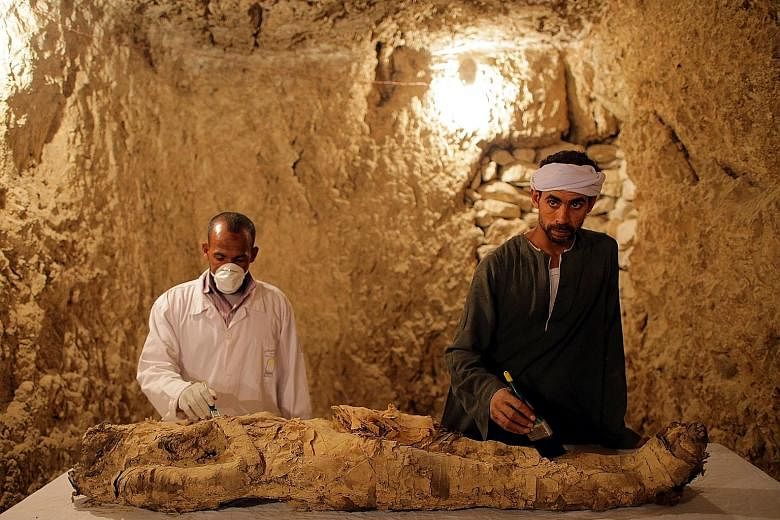 Egyptian archaeologists working on Saturday to restore a mummy found in a tomb at Draa Abul Naga necropolis on Luxor's west bank.