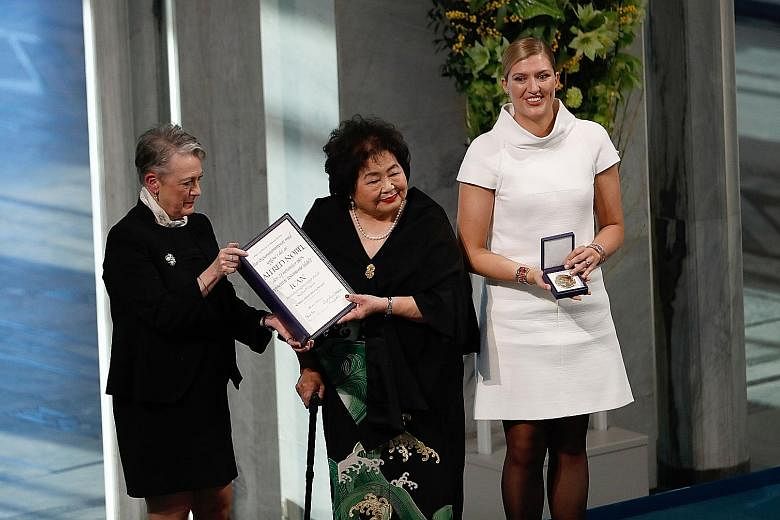 (From left) Norwegian Nobel Committee chairman Berit Reiss-Andersen presenting the peace prize to Hiroshima bombing survivor Setsuko Thurlow and Ican head Beatrice Fihn in Oslo yesterday.