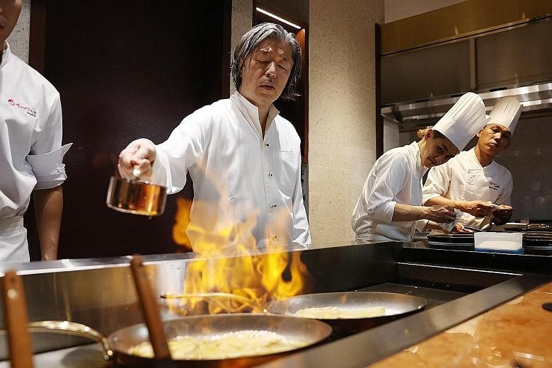 Japanese chef Masayasu Yonemura making Crepes Suzette, the closing act in a theatrical dining concept he is rolling out at Teppan by Chef Yonemura.