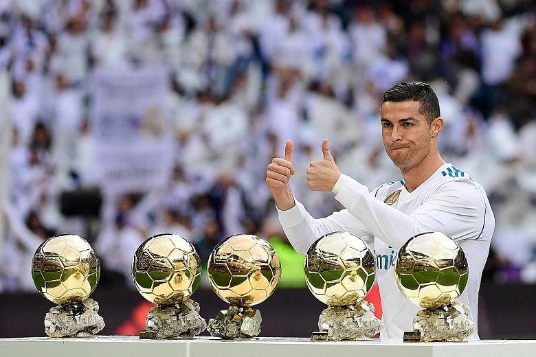 Real Madrid's Cristiano Ronaldo posing with his five Ballon d'Or trophies prior to the Sevilla kick-off. He put on a display that befitted his status as the best player in the world.