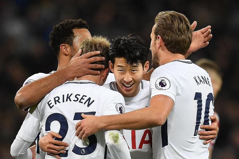 Christian Eriksen being mobbed by his Spurs team-mates (from far left) Moussa Dembele, Son Heung Min and Harry Kane after the Danish midfielder's 74th-minute strike in the 5-1 thrashing of Stoke on Saturday. Tottenham will look to move back up the ta