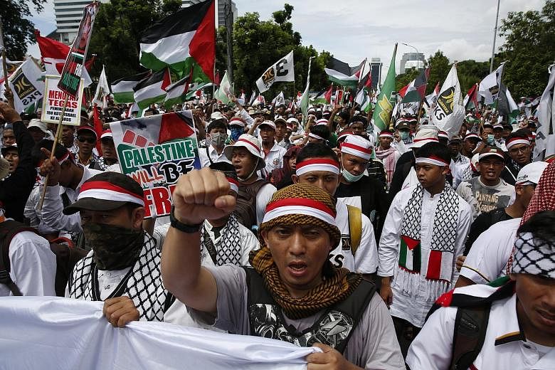 Protesters at a rally outside the US Embassy in Jakarta yesterday. They were among thousands who have protested in Asian cities against the controversial US decision to recognise Jerusalem as the capital of Israel.