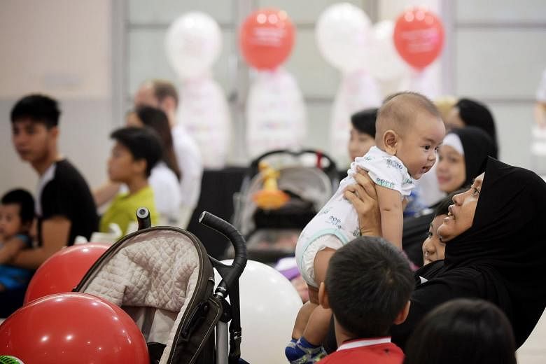 Housewife Nor Aisha Mohamad Jupri with her sixth child, three-month-old Mohamad Rayyan Naqeeb, at the launch of Singapore's first diaper bank, held at the Jurong Spring Community Club. The scheme, called Huggies Singapore Diaper Bank @ South West, is
