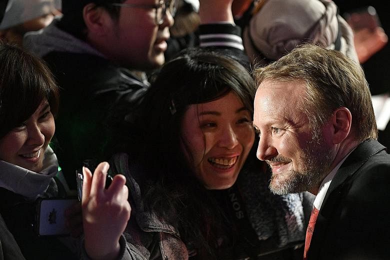 Star Wars: The Last Jedi's director Rian Johnson with fans during the film's red-carpet event in Tokyo, Japan, earlier this month. Actress Carrie Fisher, who died in December last year, stars as General Leia in The Last Jedi.