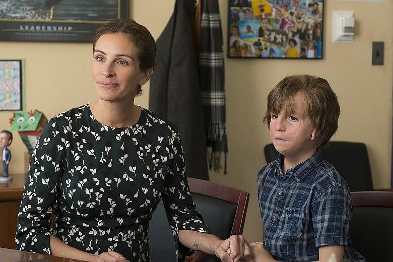 Julia Roberts stars with young actor Jacob Tremblay (wearing heavy prosthetics) in Wonder, which is based on the best-selling book of the same name.