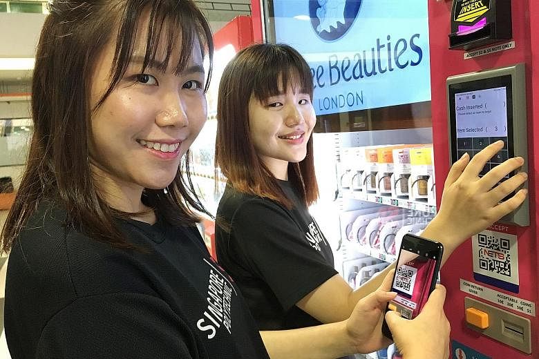 Clockwise from above: Singapore Poly's vending machine cluster offers products like cosmetics and magazines. Students Jermain Hong (far left), 20, and Goh Xin Rui, 19, try out a machine offering cosmetics.