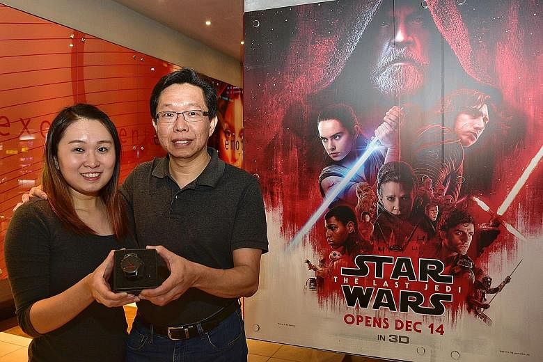 IT specialist Charles Poh and his daughter Celine were among 100 people who watched Star Wars: The Last Jedi, courtesy of The Straits Times yesterday, ahead of the movie's commercial opening today. Miss Poh also won a watch in a lucky draw.