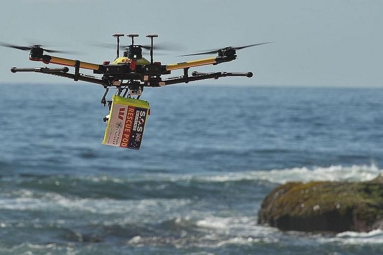 A shark-spotting drone with a safety flotation device attached flying over Bilgola beach north of Sydney. A drone camera captures thousands of images to develop an algorithm that can identify different ocean objects. The drones can spot sea creatures