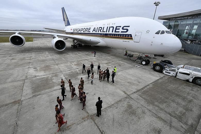 SIA pilots and cabin crew with the new A-380 superjumbo at the Airbus Delivery Centre in Toulouse, France. The upgraded aircraft has a greater emphasis on premium economy, increasing the number of seats in that cabin to 44 from 36. The number of econ