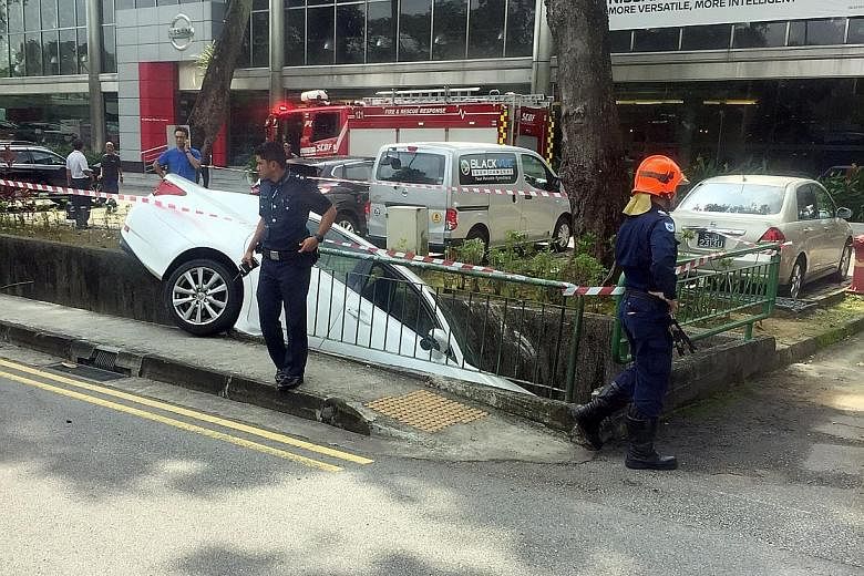 The 67-year-old driver of the white car was conscious when taken to National University Hospital. The police were alerted to the accident in Bukit Timah at 10.59am yesterday.
