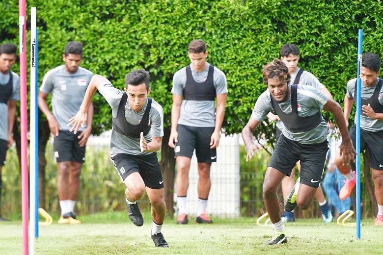 Faris Ramli and Madhu Mohana going through their paces at national team training last month. The Lions conceded late goals in international games recently and improving players' fitness is a key pillar of the FAS' revamp of the domestic league.