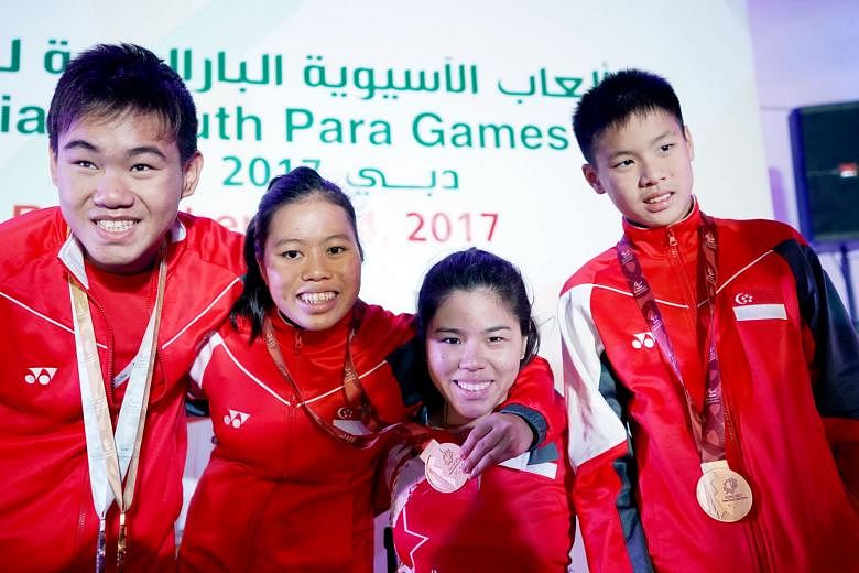 Left: Games chef de mission Yip Pin Xiu (second from right) with para-swimmers (from far left) Wong Zhi Wei (three golds, two silvers), Danielle Moi (two silvers, one bronze), and Colin Soon (two bronzes). Below: Para-sprinter Lionel Toh won his firs