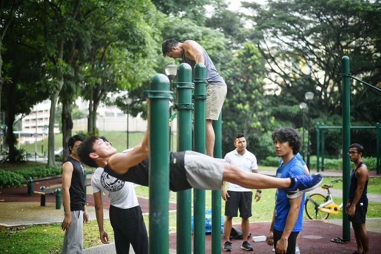 PushPullGive, founded in February, runs paid fitness sessions for the public, like a calisthenics session at Tiong Bahru Park (above), and for corporates, like bootcamp sessions (top), then pumps the proceeds into free sessions for marginalised young