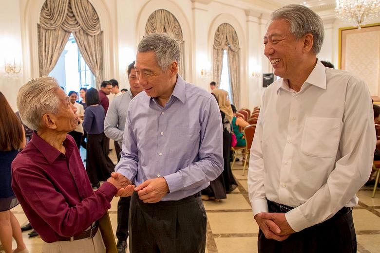 Above: Mr Puteh Mahamood, 84, started work at the Elections Department on May 15, 1947 as a teenager. Left: Mr Puteh with Prime Minister Lee Hsien Loong and Deputy Prime Minister Teo Chee Hean on Nov 8, when he received his 70 years long-service meda