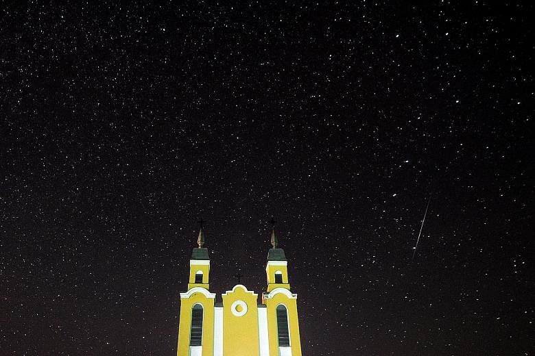 It was like a magical scene right out of a story book as a meteor or shooting star streaked across the sky above a church in Krevo village, north-west of Minsk, Belarus, yesterday during the annual Geminid meteor shower. Astronomers had expected a "s