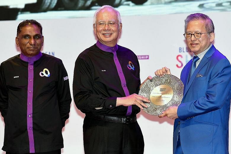 Mr Kwek Leng Beng receiving the Global Blue Ocean Shift Award for his efforts from Malaysian Prime Minister Najib Razak at the Global Entrepreneurship Community Summit in Kuala Lumpur on Wednesday.