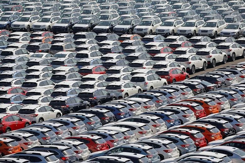 Newly manufactured Subaru cars await export in a port in Yokohama, Japan. The improved business confidence is a sign that Japan's economy is gathering momentum from robust exports and booming corporate profits.