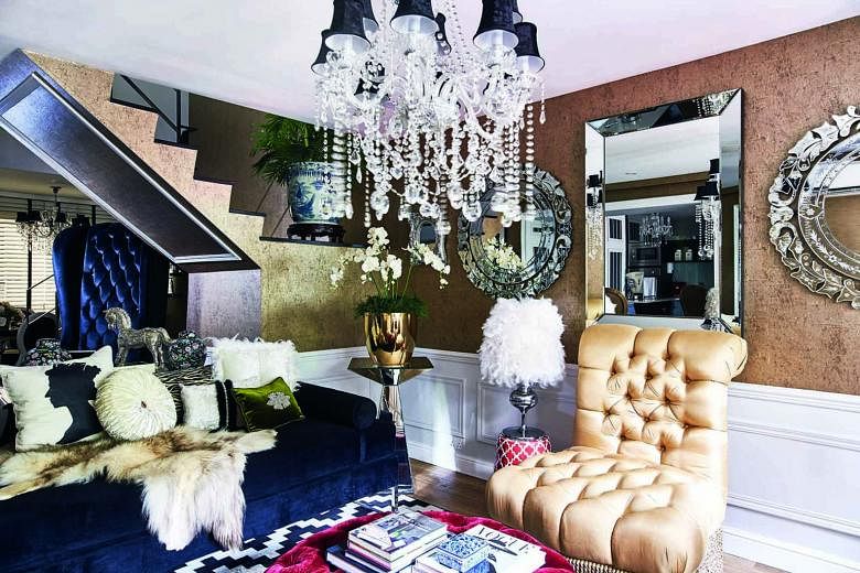 (Far left) A neutral palette of beige and white for furnishings balances the luxe look of the living room. (Left) The walls are covered with gold textured wallpaper and a birdcage-inspired chandelier creates an attractive focal point. (Top) The walls