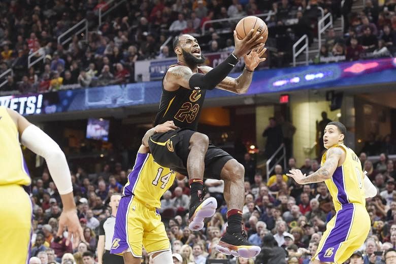Cleveland Cavaliers forward LeBron James is fouled by Los Angeles Lakers forward Brandon Ingram while driving to the basket during the Cavs' 121-112 victory. James had 25 points, 12 rebounds and 12 assists for his 59th career triple-double in his 15t