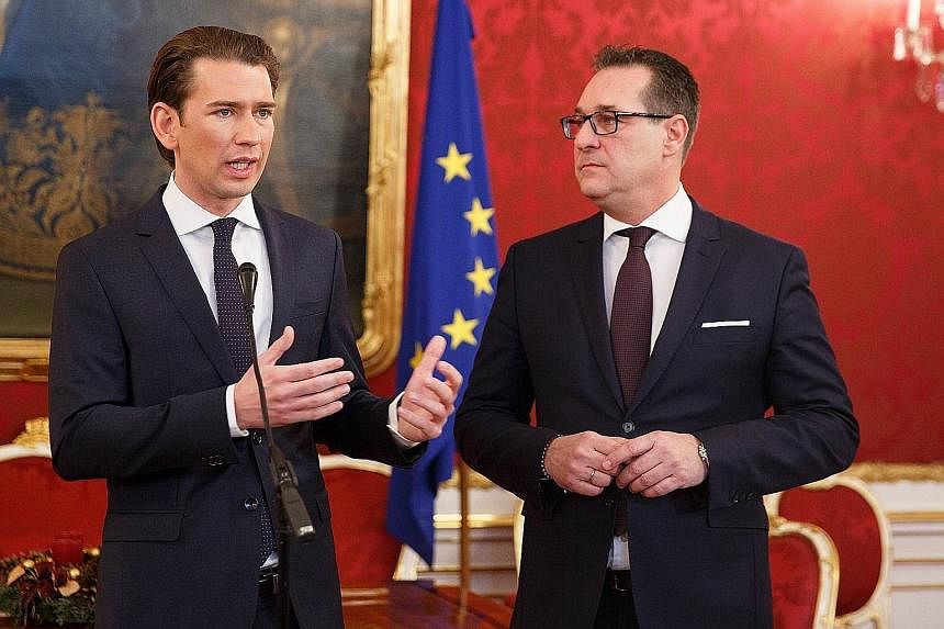 Mr Sebastian Kurz (near right) of the conservative People's Party and Mr Heinz-Christian Strache of the far-right Freedom Party have agreed to form a coalition government in Austria.