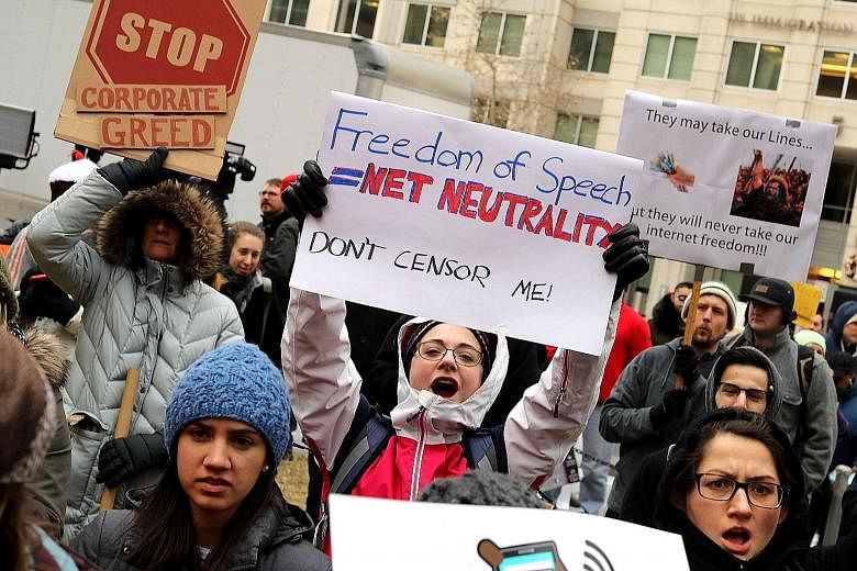 Demonstrators outside the FCC building in Washington protesting against the end of Net neutrality rules on Thursday.
