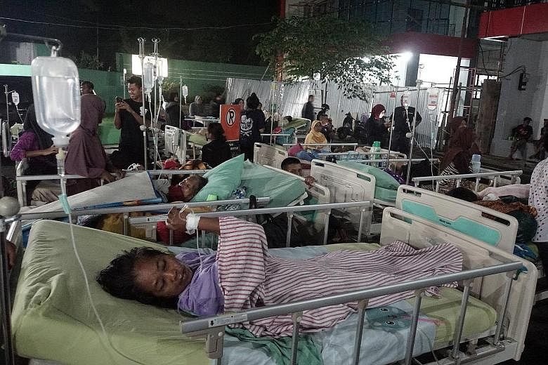 Left: A man going through the rubble of his collapsed house yesterday after a 6.5-magnitude earthquake hit Sumelap Village in Tasikmalaya, West Java, just before midnight on Friday. Below: Patients in Banyumas' regional public hospital in Central Jav