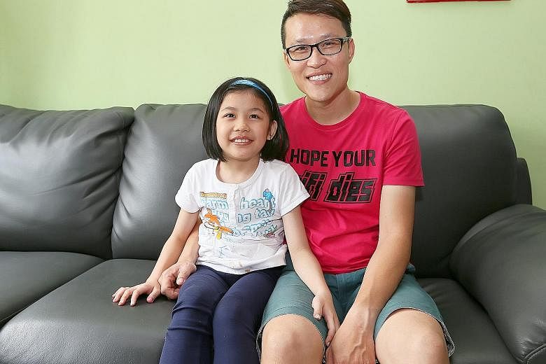 Mr Chew Tuck Choy with his daughter Zecia, who has Gaucher disease. Most of the family's savings are spent on her treatment, which is paid for with the help of government aid.