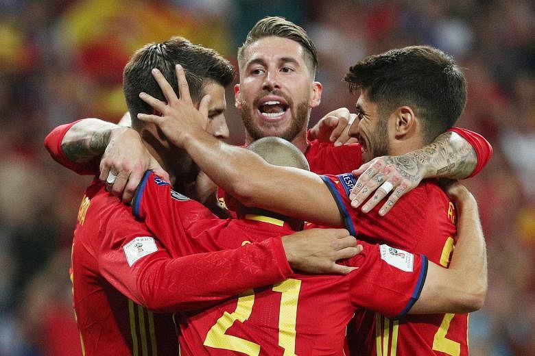 Spain captain Sergio Ramos (centre) and team-mates celebrating a goal during their World Cup qualifying campaign. The government's demand for fresh elections for the presidency of the domestic football federation is seen by Fifa as external political