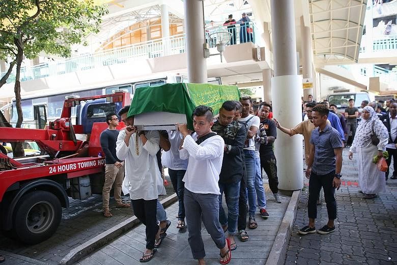 The body of Mr Khairul Anwar Mohd Sani arriving at his home in Whampoa Drive from the mortuary. A friend said Mr Khairul worked as a logistics driver and a part-time Grab and Uber driver.
