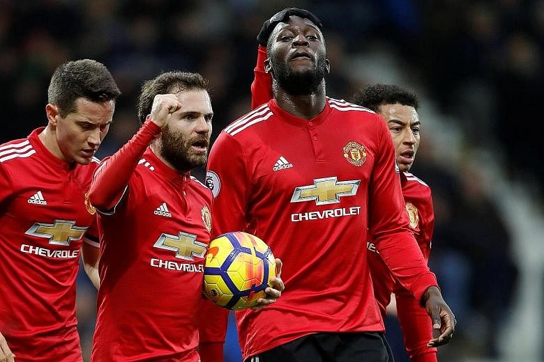 Manchester United's Romelu Lukaku manages a subdued celebration with (from far left) Ander Herrera, Juan Mata and Jesse Lingard for his opening goal against West Brom, where he spent a season on loan. United fended off a late fightback by the hosts t