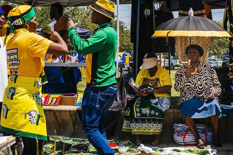 Supporters of South Africa's African National Congress (ANC) at a stall during the party's 54th national conference in Johannesburg yesterday. Thousands of ANC delegates began electing their next leader in a vote seen as a key moment in the country's