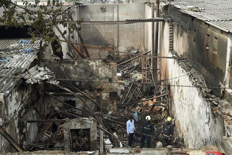 The authorities in Mumbai are investigating the blaze which destroyed a sweet shop, killing 12 and injuring four.