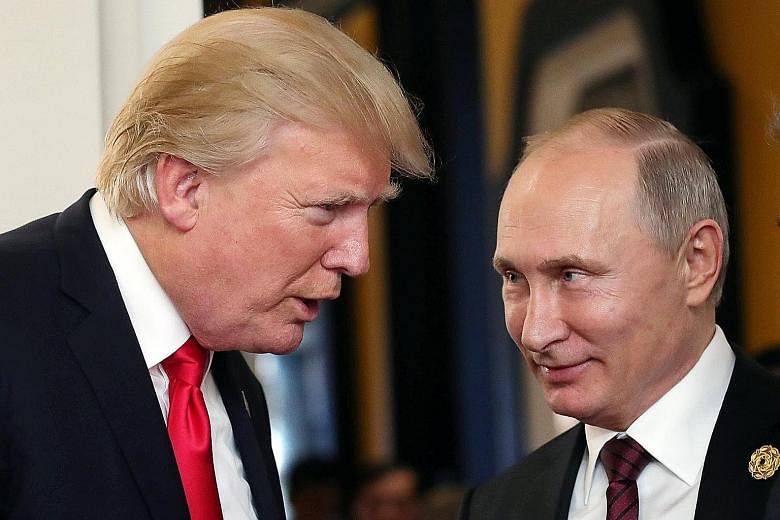 US President Donald Trump and his Russian counterpart Vladimir Putin at the Apec summit in Danang, Vietnam, on Nov 11. Mr Putin called Mr Trump on Sunday to thank him for information from the CIA that allowed Russia's law enforcement agencies to deta