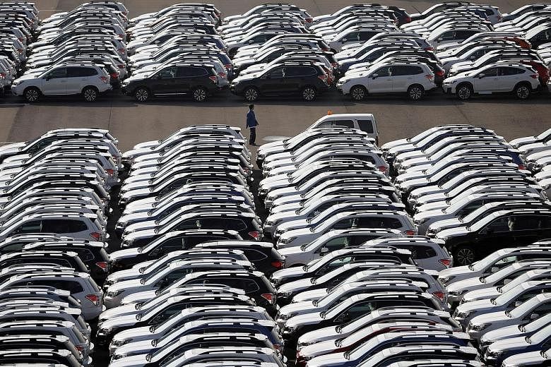 Made-in-Japan cars waiting to be exported at Yokohama's port. Data from the Ministry of Finance shows Japanese exports grew 16.2 per cent in the year to November.