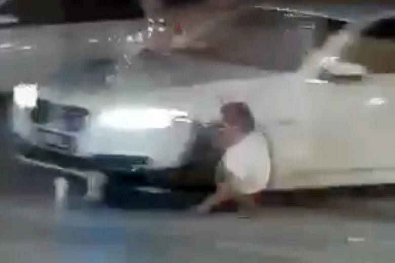 Screengrabs from video footage showing the victim being run over by the assailants' car before it sped off. The victim, who was assaulted and stabbed, died.